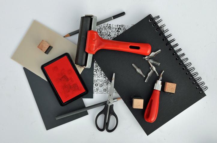 Studio set up flat lay. Art and craft hobby materials. Lino cutting block and relief printing